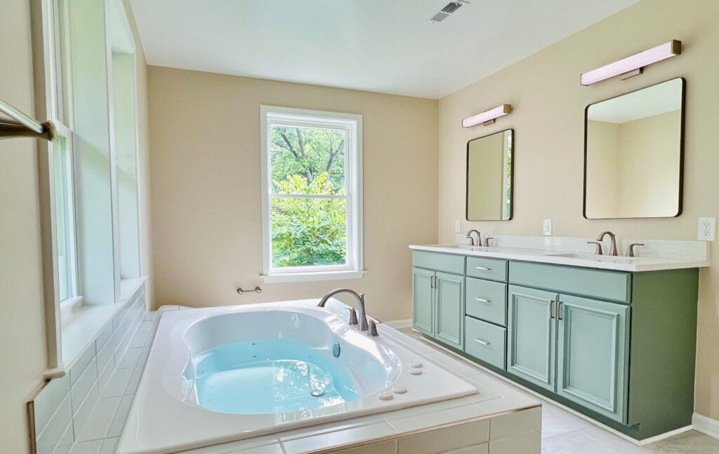 Luxury bathroom interior with whirlpool bathtub and double vanity with quartz countertop