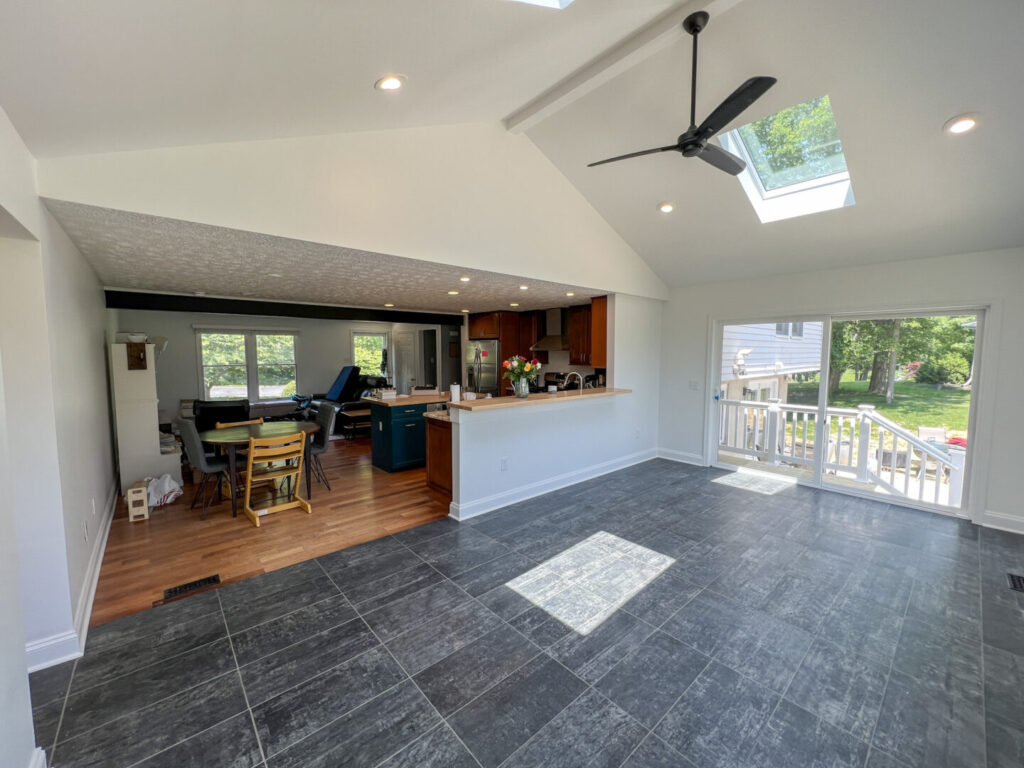 Kitchen Expansion Addition with Vaulted Ceiling, Tile Flooring, and Bar Stool Countertop Ledge.